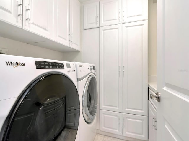 laundry room featuring cabinet space and washing machine and clothes dryer