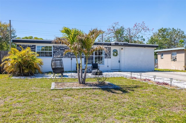 view of front of house featuring a front yard and fence