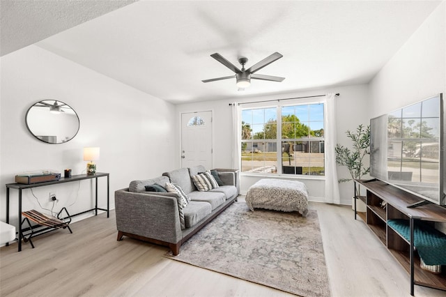 living room featuring ceiling fan and wood finished floors