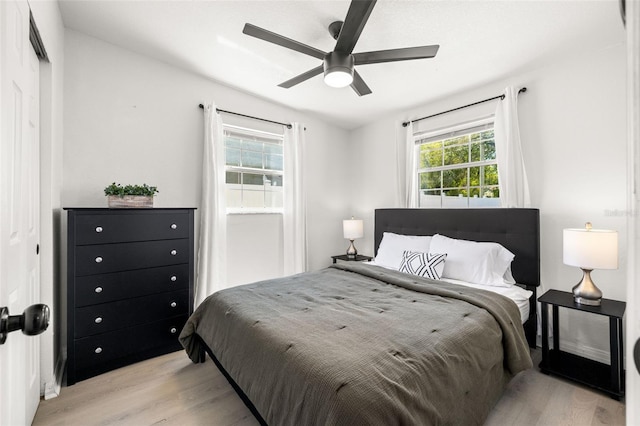 bedroom with light wood-style flooring and a ceiling fan