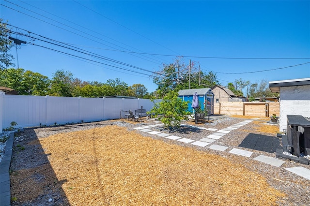 view of yard featuring an outbuilding and a fenced backyard