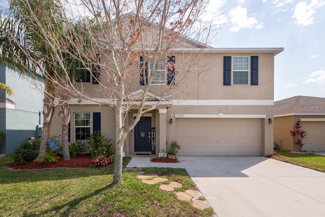 traditional-style house with stucco siding, an attached garage, concrete driveway, and a front lawn