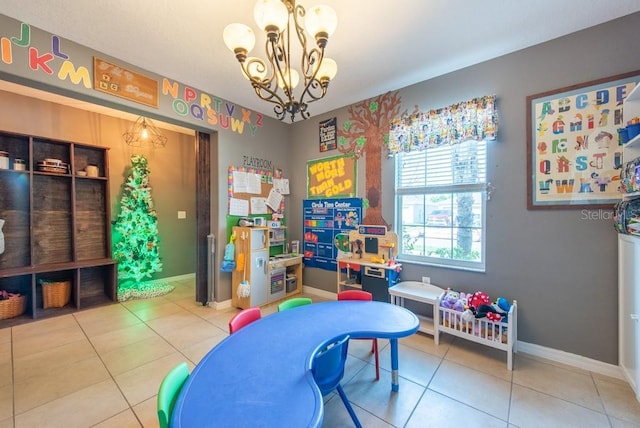 rec room with an inviting chandelier, tile patterned floors, and baseboards