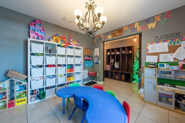 game room featuring tile patterned floors and a chandelier