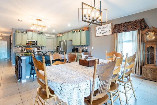 dining space with a notable chandelier, visible vents, and light tile patterned floors