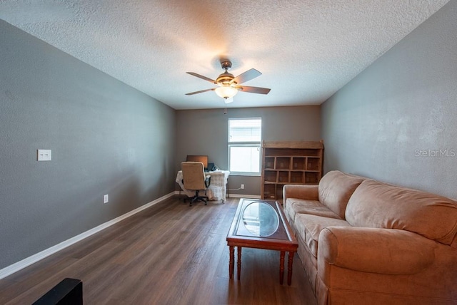 living area with baseboards, a textured ceiling, wood finished floors, and a ceiling fan