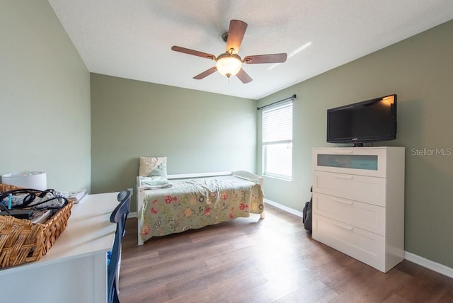 bedroom featuring a ceiling fan, wood finished floors, and baseboards