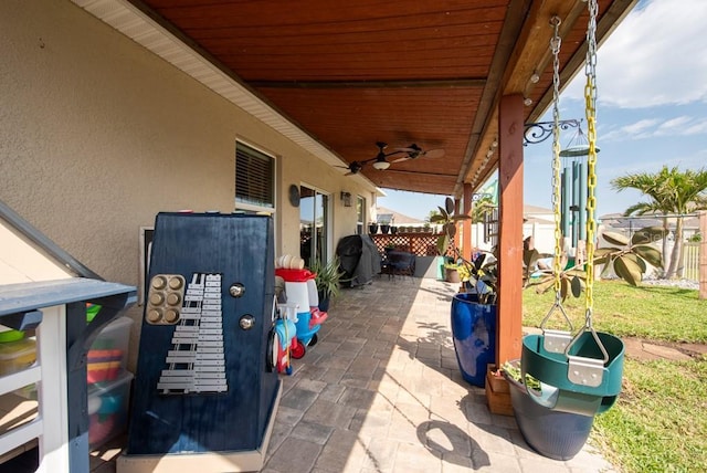 view of patio / terrace featuring grilling area, ceiling fan, and fence