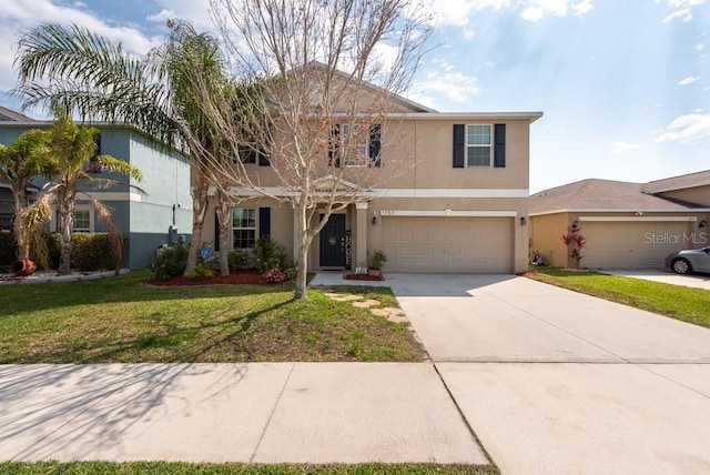 traditional-style house featuring stucco siding, driveway, an attached garage, and a front lawn