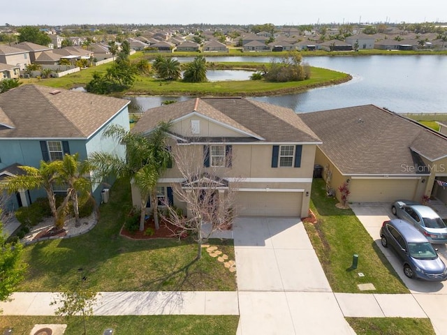 birds eye view of property with a residential view and a water view