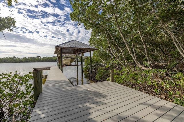 dock area with a water view and boat lift