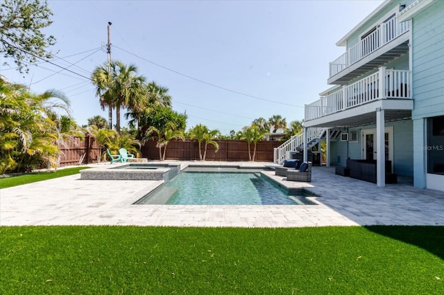 view of swimming pool with a yard, a fenced backyard, stairs, and a patio area