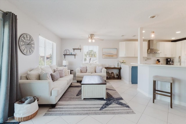 living room featuring light tile patterned flooring, recessed lighting, baseboards, and ceiling fan