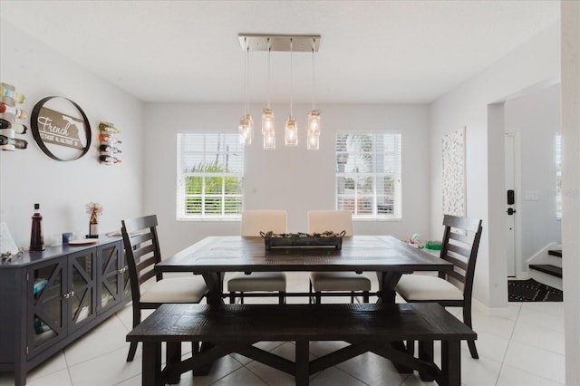 dining space with light tile patterned floors and baseboards