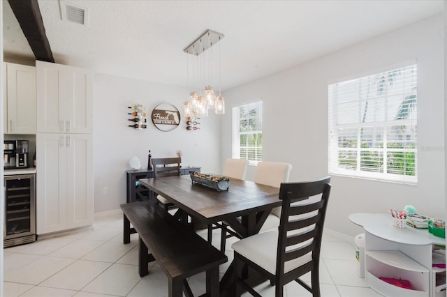 dining space with wine cooler, plenty of natural light, and light tile patterned floors