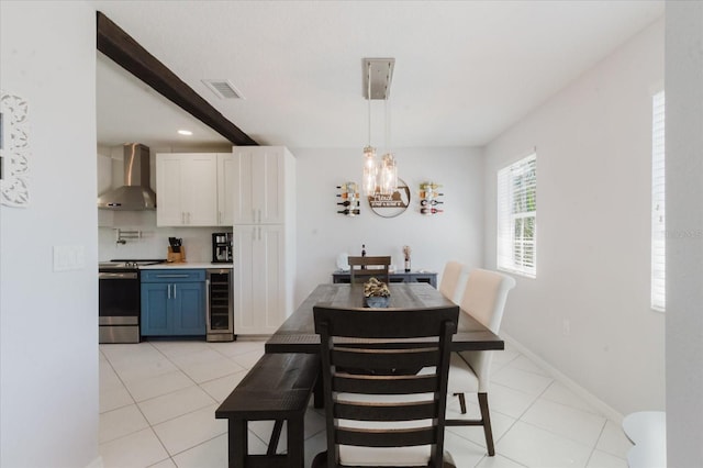 dining area featuring visible vents, a notable chandelier, beverage cooler, and light tile patterned flooring