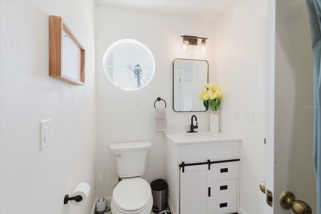 half bathroom featuring toilet and vanity