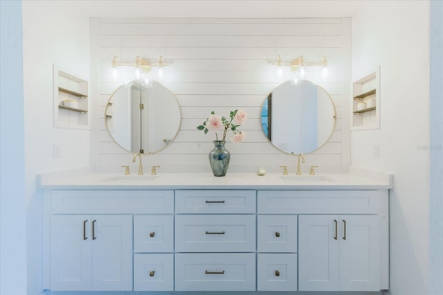 bathroom with double vanity, decorative backsplash, and a sink