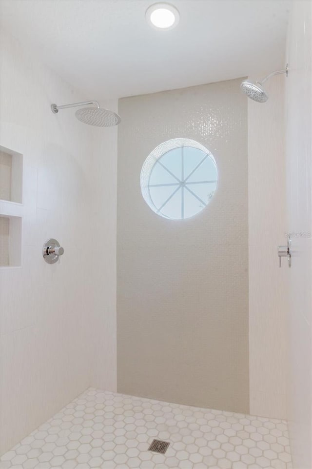 full bath featuring tiled shower