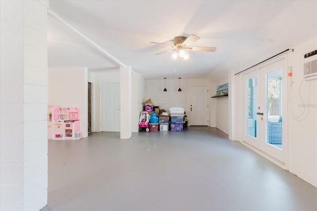 interior space featuring a wall mounted air conditioner, concrete flooring, and ceiling fan