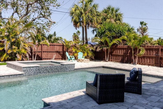 view of swimming pool featuring a patio area, a fenced in pool, an in ground hot tub, and a fenced backyard