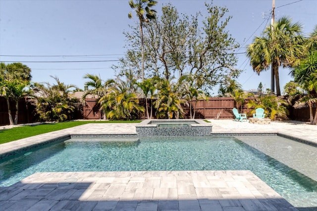 view of swimming pool featuring a patio, a fenced backyard, and a pool with connected hot tub