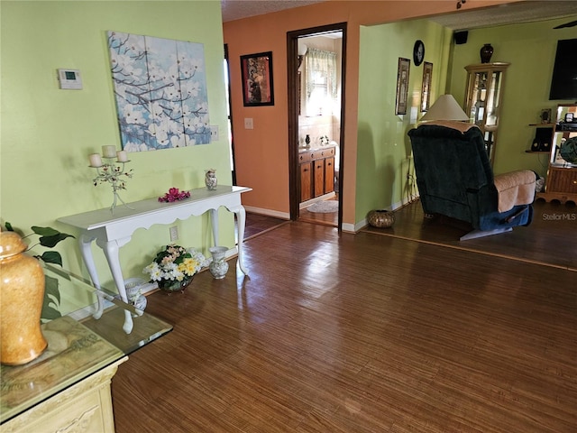 interior space featuring baseboards and wood finished floors