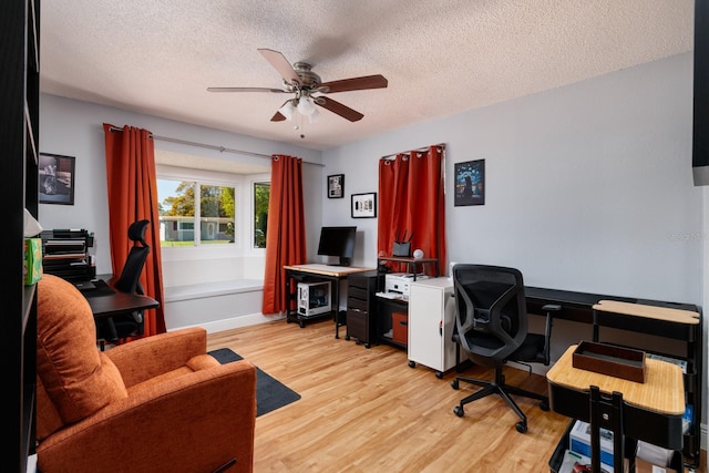 office area featuring a textured ceiling, ceiling fan, and wood finished floors