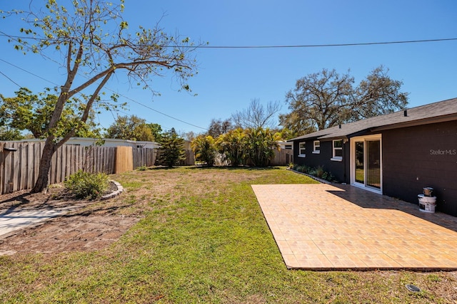 view of yard with a patio and a fenced backyard