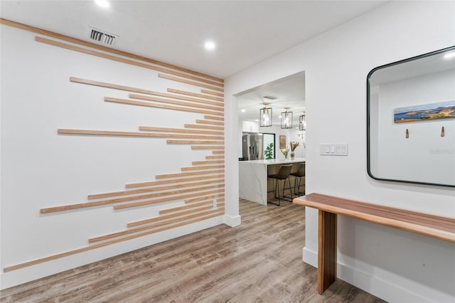 interior space with visible vents and wood finished floors