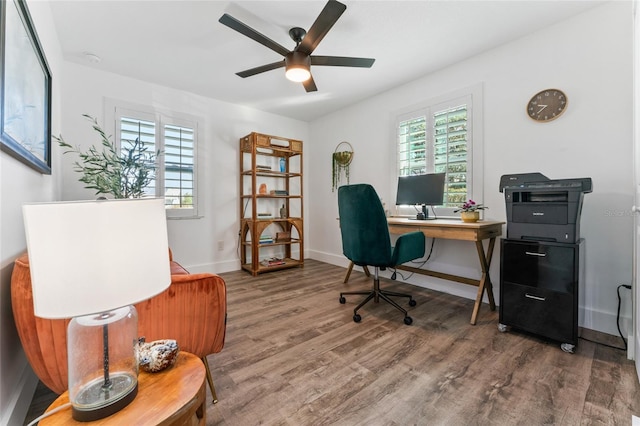 office space featuring a ceiling fan, baseboards, and wood finished floors