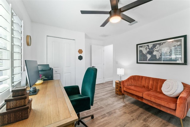 office featuring ceiling fan, visible vents, and wood finished floors