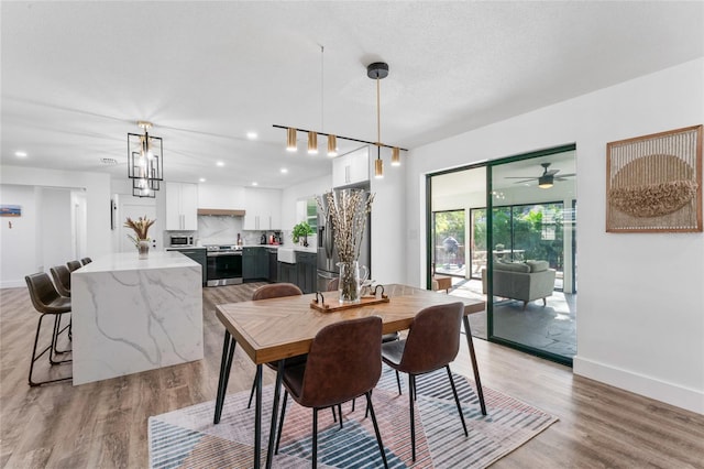 dining space featuring recessed lighting, baseboards, and light wood-style floors