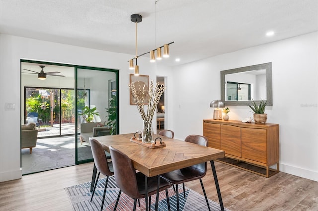 dining room with recessed lighting, light wood-type flooring, and baseboards