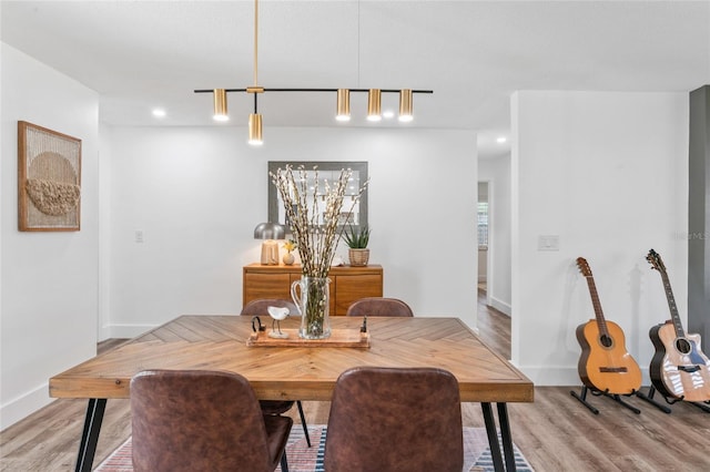 dining room with recessed lighting, light wood-type flooring, and baseboards