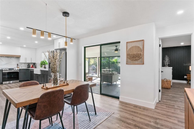 dining room with recessed lighting, baseboards, and light wood-style floors