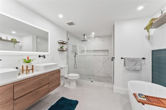 full bath with a freestanding bath, visible vents, a marble finish shower, and a sink