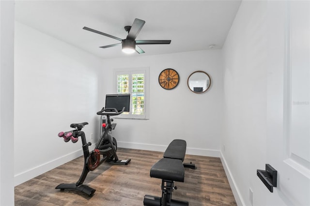 exercise area with a ceiling fan, wood finished floors, and baseboards