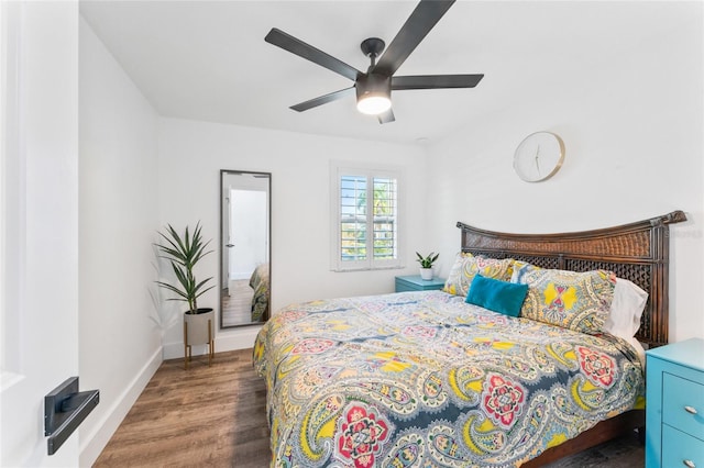 bedroom with baseboards, wood finished floors, and a ceiling fan