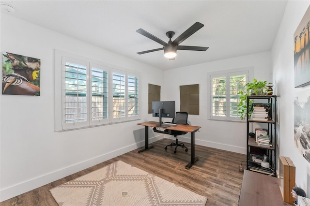 office space featuring ceiling fan, baseboards, and wood finished floors