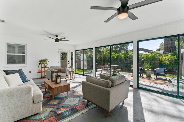 sunroom / solarium with a ceiling fan and visible vents