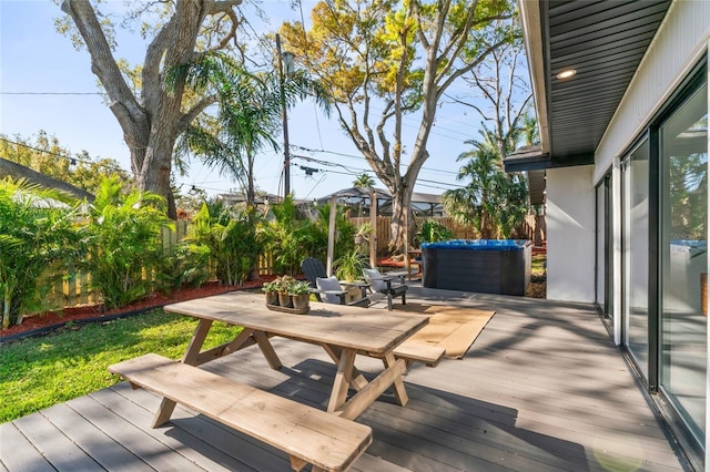 wooden terrace with a fenced backyard