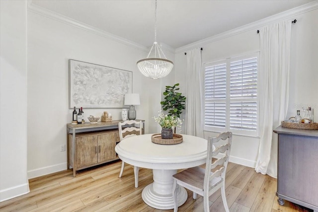 dining area featuring an inviting chandelier, light wood-type flooring, baseboards, and ornamental molding