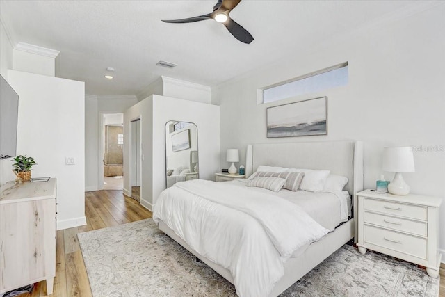 bedroom with baseboards, visible vents, ceiling fan, crown molding, and light wood-type flooring