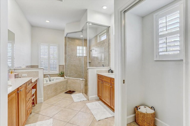 full bathroom with a tile shower, tile patterned floors, a garden tub, and two vanities