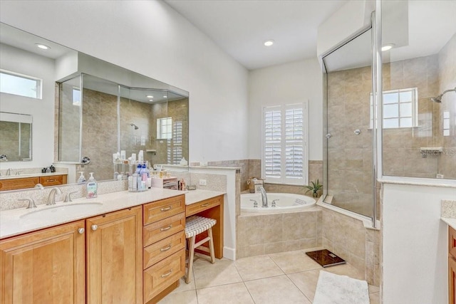 full bath featuring tile patterned flooring, plenty of natural light, tiled shower, and vanity