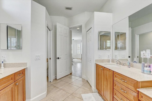 bathroom with visible vents, toilet, tile patterned flooring, baseboards, and vanity