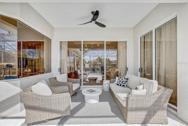 interior space featuring outdoor lounge area and a ceiling fan