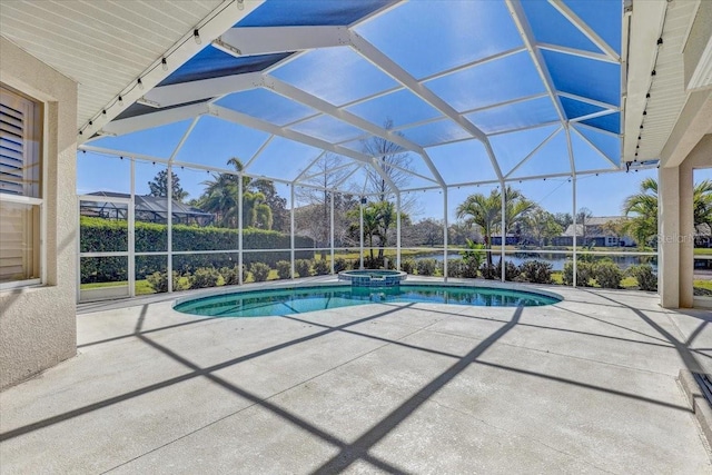 view of pool with a patio area, glass enclosure, and a pool with connected hot tub