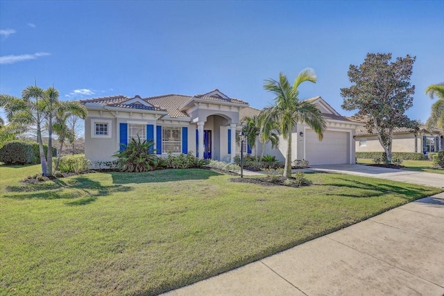 mediterranean / spanish-style home featuring a tiled roof, concrete driveway, a front yard, stucco siding, and an attached garage